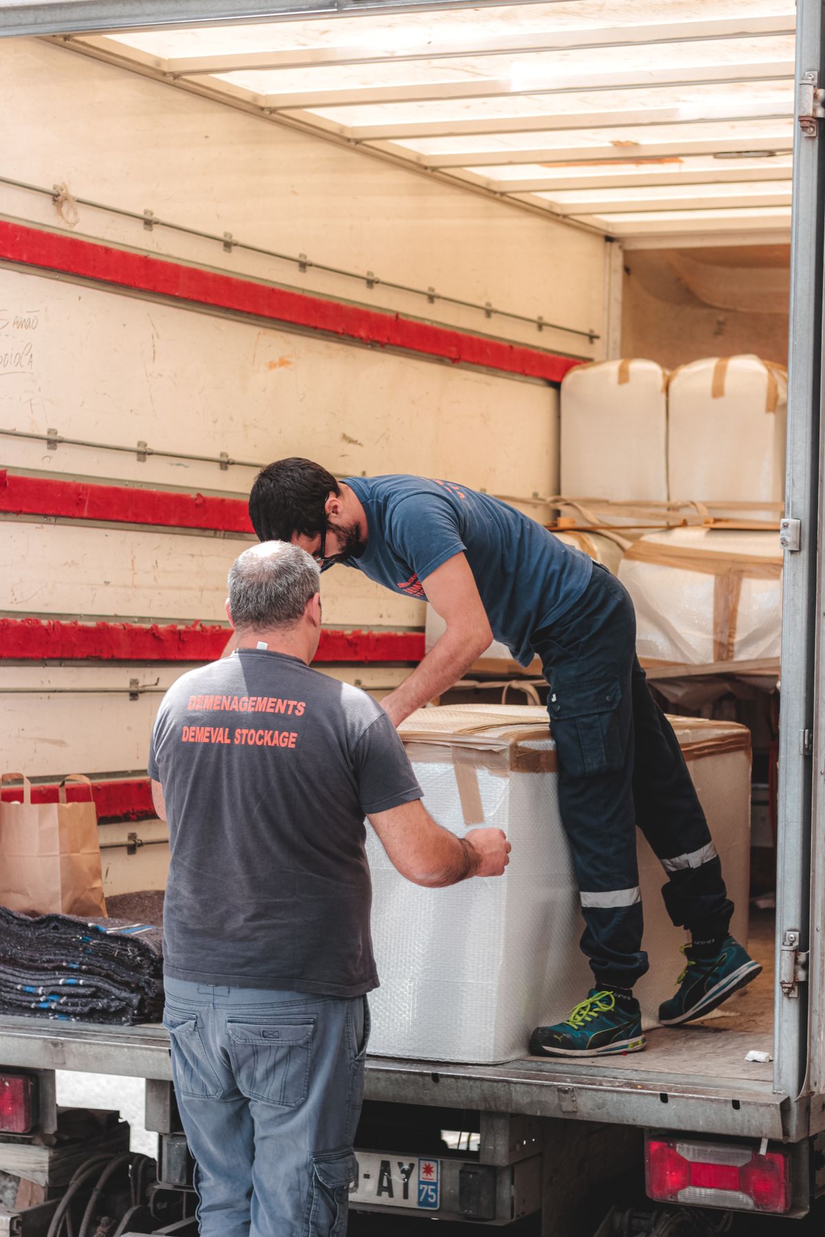 Workers unloading delivery truck
